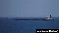 GIBRALTAR -- A British Royal Navy patrol vessel guards the oil supertanker Grace 1, that's on suspicion of carrying Iranian crude oil to Syria, as it sits anchored in waters of the British overseas territory of Gibraltar, historically claimed by Spain, Ju