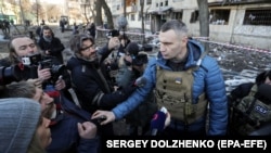 Kyiv Mayor Vitali Klitschko speaks with reporters near a shelled residential building in Kyiv last week. 