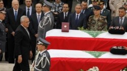 Lebanese President Michel Suleiman pays his respects to intelligence chief Wissam al-Hassan and bodyguard Ahmed Sahyouni at a funeral on October 21 for the slain men, who died in a bomb explosion on October 19.