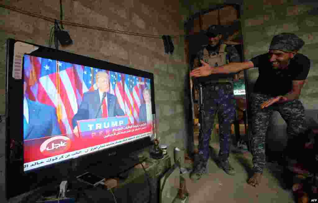 Members of the Iraqi armed forces in the village of Arbid on the southern outskirts of Mosul react as they watch U.S. President-elect Donald Trump giving his victory speech during ongoing military operations to retake Mosul from the Islamic State extremist group. (AFP/Ahmad al-Rubaye)