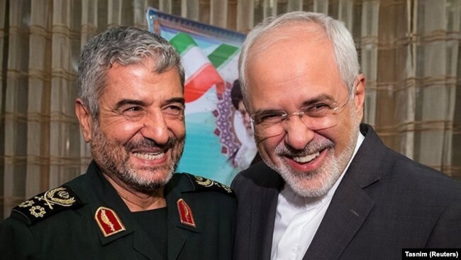 Islamic Revolutionary Guard Corps (IRGC) commander Mohammad Ali Jafari (L) and Iranian Foreign Minister Mohammad Javad Zarif smile during a coordination meeting for the 40th anniversary of the Islamic Revolution, in Tehran, October 9, 2017