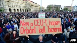 A man holds up a sign saying, "Don't close CEU, Orban in jail," as students and teachers of the Central European University protest with sympathizers in front of parliament in Budapest on April 9.