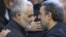 Commander of Quds force, Qassem Soleimani (left) shakes hands with President, Mahmoud Ahmadinejad, in the funeral of his mother, 2013.