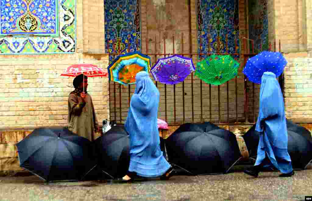 An Afghan man sells umbrellas on a roadside in Herat. (epa/Jalil Rezayee)