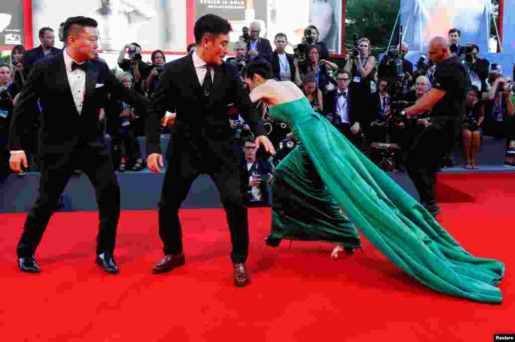 South Korean actress Moon So-ri trips during a red-carpet event for the movie The Light Between Oceans at the 73rd Venice Film Festival in Venice, Italy. (Reuters/Alessandro Bianchi)