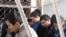 Ten ethnic Uzbek men await their sentencing inside a holding cage in the courtroom in Osh. Five of the men received life sentences for the brutal murders. 