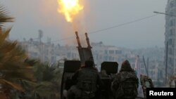 Free Syrian Army fighters firing an anti-aircraft weapon in a rebel-held area of Aleppo last year