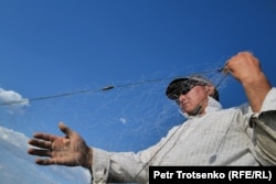 Nurzhan working with a fishing net