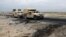 An Afghan military convoy drives past the site of a car bombing where U.S soldiers were killed near Bagram air base on April 9.