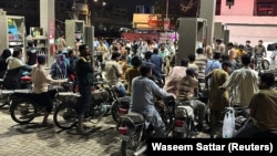 People in Karachi, Pakistan, waiting to buy gas, as fuel prices rise, on April 2