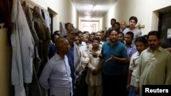 Southj Asian migrant workers gather as they speak to journalists at their accommodation in Qadisiya labour camp, Saudi Arabia on August 17.