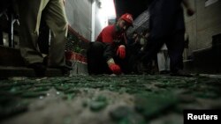 A worker collects evidence at the site of a deadly bomb blast in Peshawar, Pakistan on February 4.