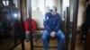 Viktar Skrundzik (in blue jacket) and Valyantsin Bushnin (in red jacket) appear in court in Slutsk on March 6.