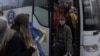 Ukrainian citizens, imprisoned in Belarus, exit a bus upon arrival in Ukraine's Chernihiv region following their release on November 22.