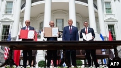 Bahrain Foreign Minister Abdullatif al-Zayani (left), Israeli Prime Minister Benjamin Netanyahu (second left), US President Donald Trump (second right), and UAE Foreign Minister Abdullah bin Zayed Al-Nahyan hold up documents after participating in the signing of the Abraham Accords at the White House in 2020. 