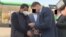 Raimbek Matraimov (left) is shown as he was detained in Bishkek on October 20.