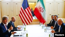 Former U.S. Secretary of State John Kerry (L) and Iran's Foreign Minister Mohammad Javad Zarif attend a bilateral meeting in Vienna, Austria, May 17, 2016.