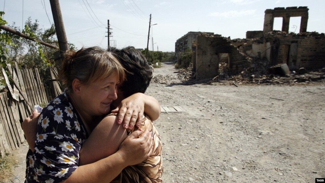 Two women hug each other amid ruins in the South Ossetian capital of Tskhinvali, which was devastated by the brief Georgian-Russian conflict in 2008. 