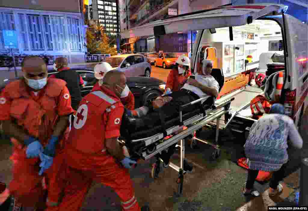 Medics shift an injured person from Najjar Hospital to another hospital in Al-Hamra area in Beirut after Port explosion, in Beirut, Lebanon, 04 August 2020.