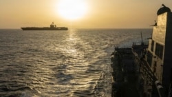 The USS Abraham Lincoln (left) conducts blockade operations in the Arabian Sea on April 16.