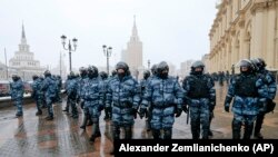 RUSSIA -- Riot police block an area protecting against demonstrators during a protest against the jailing of opposition leader Alexei Navalny in Moscow, Russia, Sunday, Jan. 31, 2021