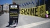 An Amnesty International activist holds a banner reading "Stop Taliban deal" in front of the EU Commission headquarters to protest against a meeting with a Taliban delegation in Brussels on June 23. 