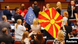 EU and Macedonian flags are seen in parliament during the July 16 debate in Skopje on a French-brokered deal aimed at settling disputes with Bulgaria and clearing the way to EU membership.