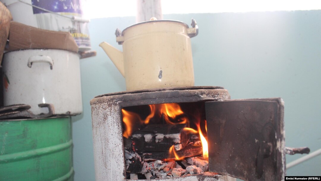 A resident of southern Kyrgyzstan prepares dinner in his apartment in April, after Uzbekistan cut off natural-gas imports.