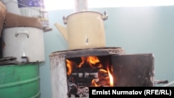 A resident of southern Kyrgyzstan prepares dinner in his apartment in April, after Uzbekistan cut off natural-gas imports.