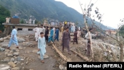 Residents look at the destruction in the aftermath of flash floods in Swat, a district in the northwestern Khyber Pakhtunkhwa Province.