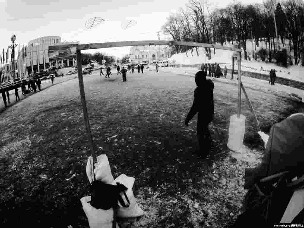 Opposition protesters play soccer on an icy pitch near European Square.