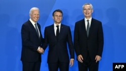 French President Emmanuel Macron (center) is welcomed by U.S. President Joe Biden (left) and NATO Secretary-General Jens Stoltenberg as they attend the NATO summit in Washington on July 10.