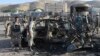 Security forces inspect a damaged car that was used during a suicide bomb attack outside the US consulate in Herat on September 13.