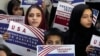 Afghan refugees in the Pakistani capital, Islamabad, hold placards during a meeting earlier this year to discuss their situation after US President Donald Trump paused refugee programs. 