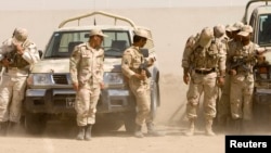 Iranian anti-narcotics policemen protect themselves from blowing sand at a police barracks on the border with Afghanistan. (file photo)