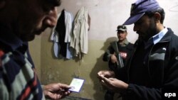 Pakistani paramilitary and police search for suspects in a residential area of Islamabad following last week massacre of schoolchildren in Peshawar.