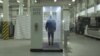 RUSSIA -- An employee walks through a disinfection tunnel manufactured by Russian company Mizotty at the company's factory in Penza, undated