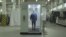 RUSSIA -- An employee walks through a disinfection tunnel manufactured by Russian company Mizotty at the company's factory in Penza, undated