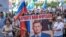 People carry a banner reading "Return Furgal to us" during a rally in support of Sergei Furgal in Khabarovsk on August 8.