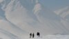 Afghanistan -- Men walk on a snow covered mountain on a cold winter's day outside Kabul, 07Feb2013