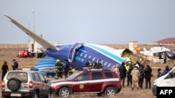 Emergency specialists work at the crash site of an Azerbaijan Airlines passenger jet near the western Kazakh city of Aqtau on December 25. 