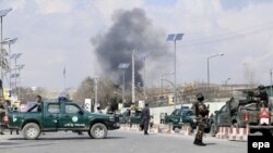 Security forces guard the area as smoke billows from the Sardar Daud Khan's Hospital, also known as Kabul Military Hospital, during an attack by suspected militants in Kabul on March 8.