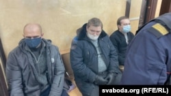 Uladzimer Kniha (left), Yauhen Raznichenka (center), and Dzmitry Furmanau appear in court in Hrodna on January 18.