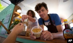 A container of yellow mealworms is offered from a food truck at a festival in Antwerp, Belgium. (file photo)