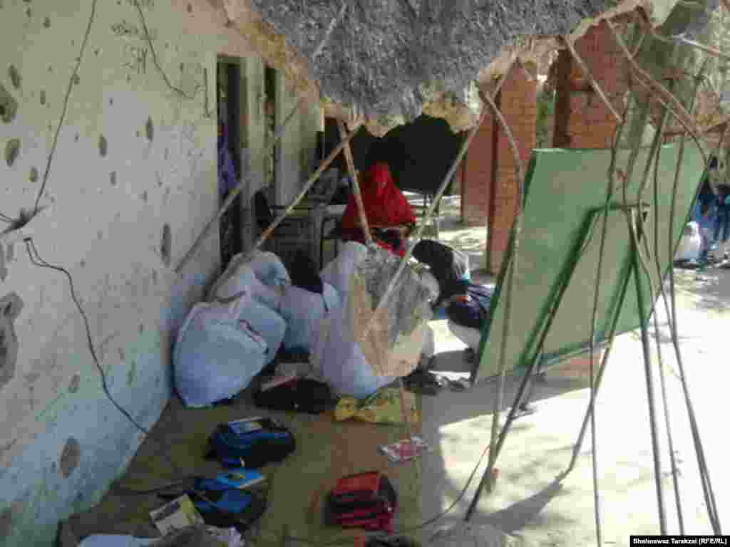 Students and their teacher hide their faces from the camera at a girls&#39; primary school in Bajaur Agency, Pakistan.