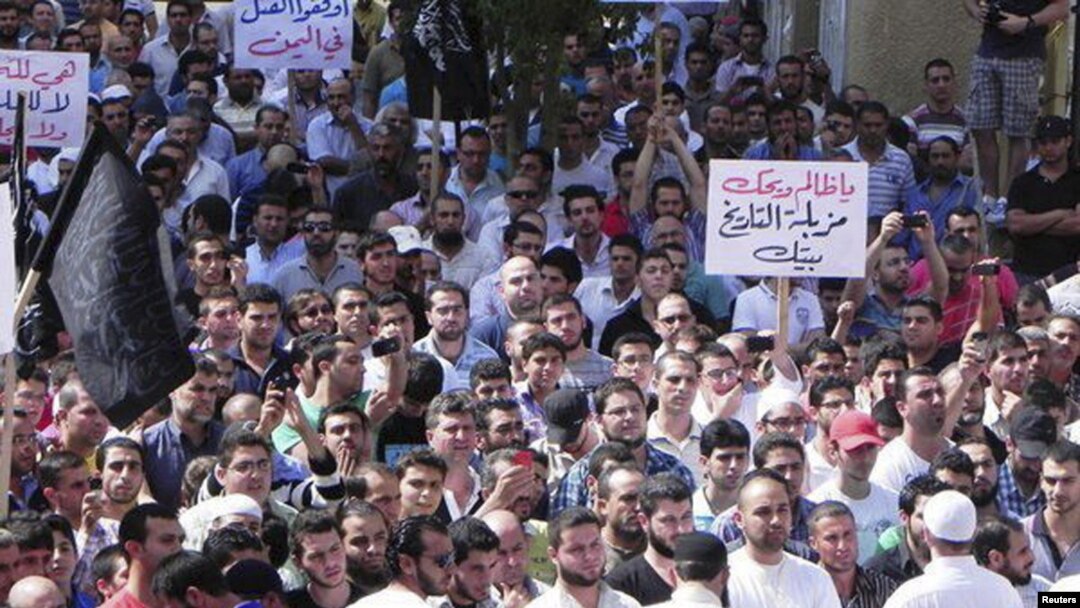Kurdish antigovernment demonstrators march through the streets in the Syrian town of Qamishli in October.