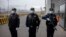 Police officers stand outside the entrance of the Urumqi No. 3 Detention Center in western China's Xinjiang region. The facility is China's largest detention center and is twice the size of Vatican City and can hold at least 10,000 inmates. 