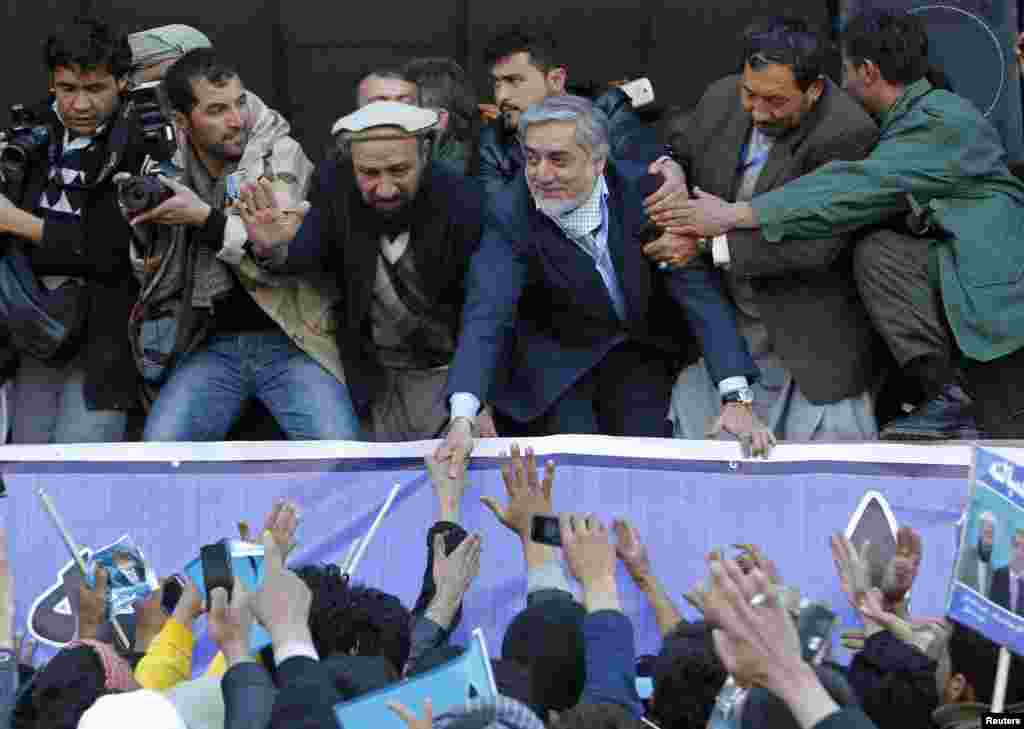 Afghan presidential candidate Abdullah Abdullah (center) shakes hands with his supporters during an election campaign rally in Kabul on February 27. (Reuters/Omar Sobhani)