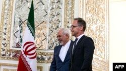 Iran's Foreign Minister Mohammad Javad Zarif (L) receives his German counterpart Heiko Maas in the capital Tehran on June 10, 2019. (Photo by ATTA KENARE / AFP)