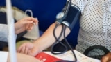 Moldova: Heart Day. Checking blood pressure in a woman